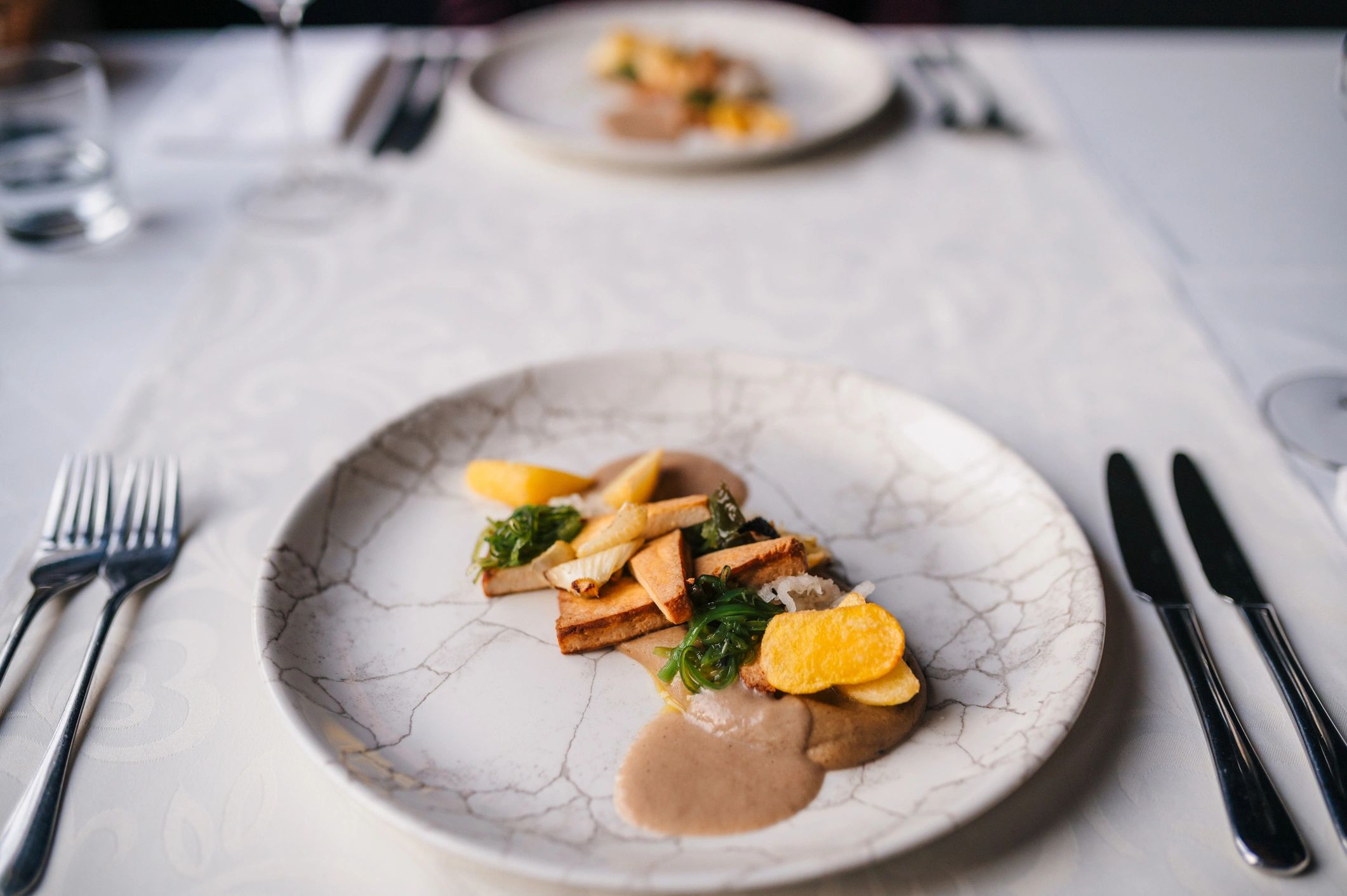 Plated entrée representing signature arepas offerings