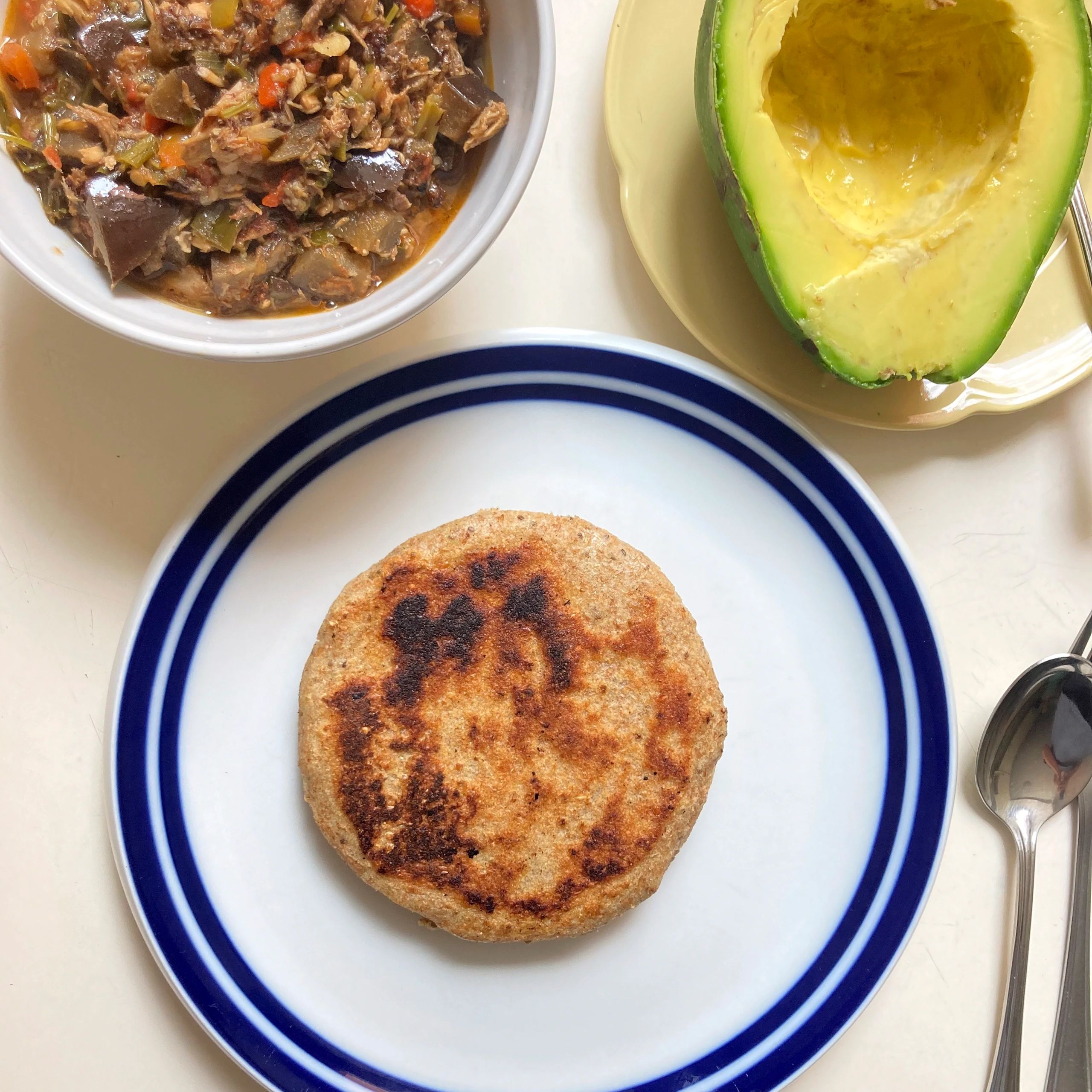 Arepa served with avocado and fresh toppings