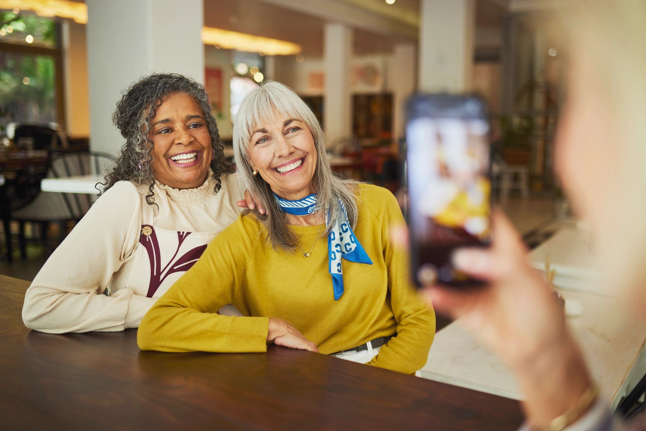 Guests smiling together at a café table